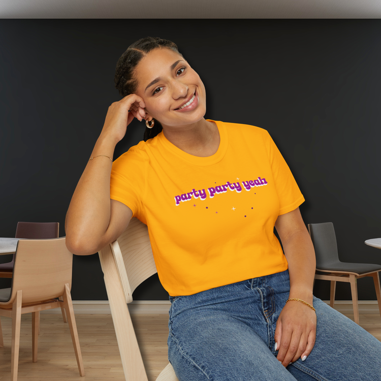 Woman wearing a bright yellow t-shirt with text, sitting in a room with chairs and tables. - Party Party Yeah T-Shirt | Retro Aesthetic K-Pop Meme Shirt, Jungkook
