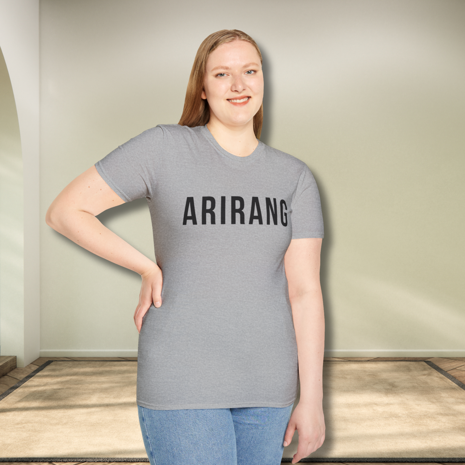 Person wearing a gray t-shirt with 'ARIRANG' printed on it, standing indoors. - Bangtan Tour 2026 Unofficial Shirt [Bias Arirang Color Vinyl Edition, Simple Text]