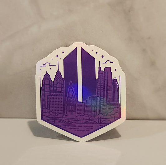 Hexagonal sticker with a cityscape design in purple on a beige background - Philadelphia skyline with a BTS Army logo in the background