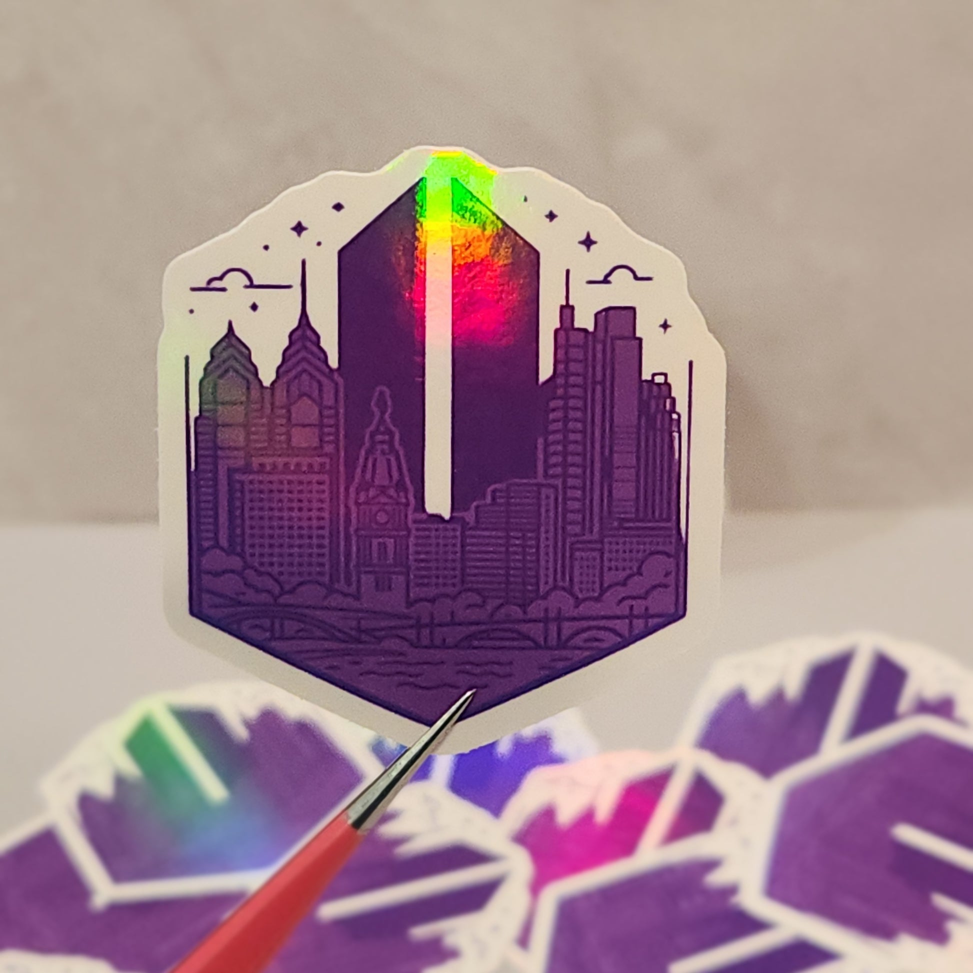 Holographic cityscape sticker with a pen on a gray background - Philadelphia skyline with a BTS Army logo in the background
