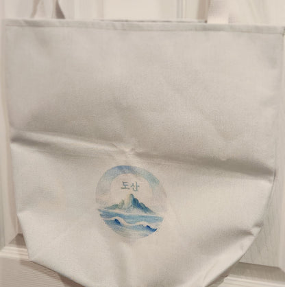 White fabric with a circular blue and white design on a white background - mugunghwa and oak leaf botanical design - white large everyday tote bag