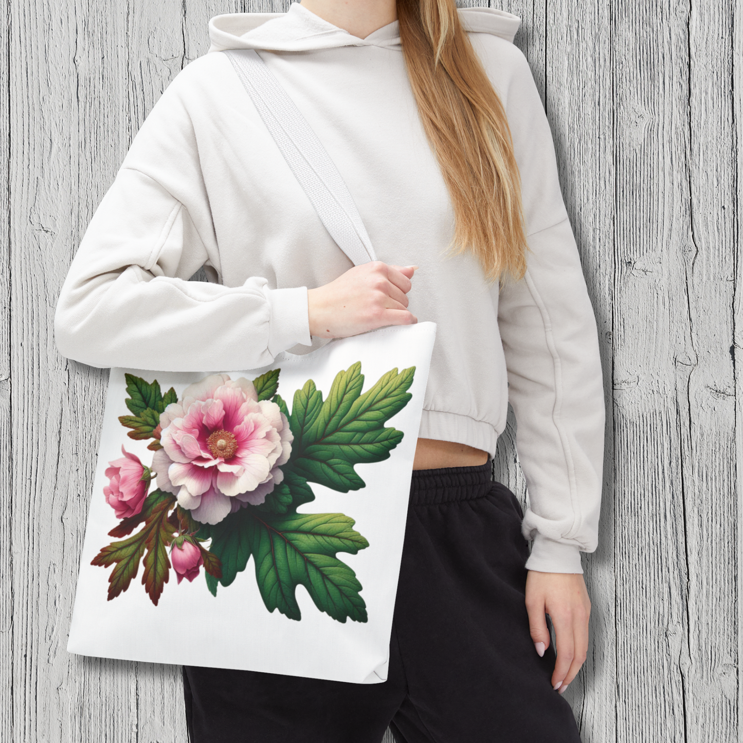 Person holding a tote bag with floral design against a wooden background - mugunghwa and oak leaf botanical design - white large everyday tote bag