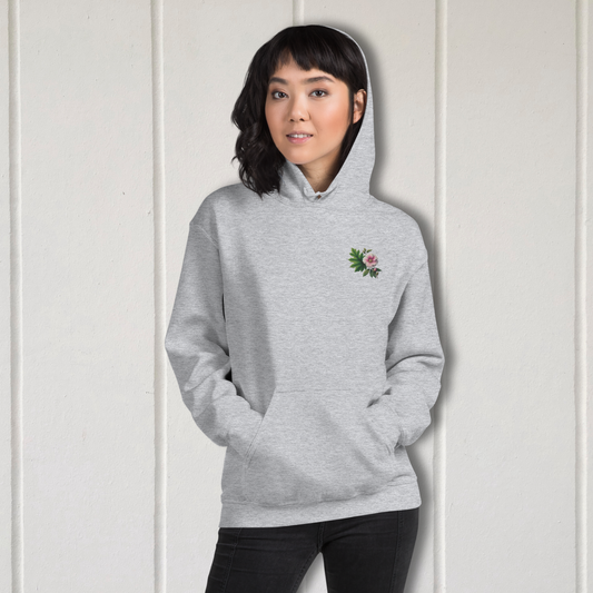 Person wearing a gray hoodie with a small floral design on a white background  - mugunghwa and oak leaf botanical design - light grey gray hooded sweatshirt, hoodie - [SAMPLE SALE] Mugunghwa & Oak Leaf Embroidered Hoodie (Unisex) | Serendipitous Landing