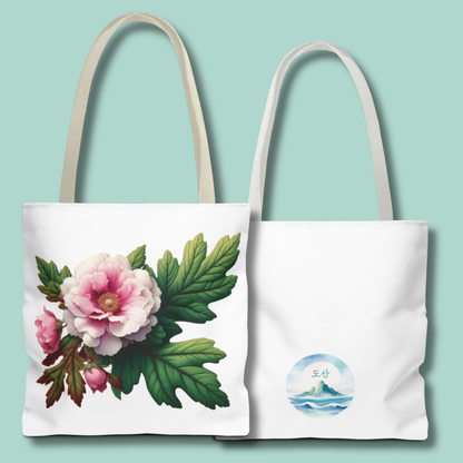 Two tote bags, one with floral design and the other with a mountain and water logo, on a light blue background. - mugunghwa and oak leaf botanical design - white large everyday tote bag