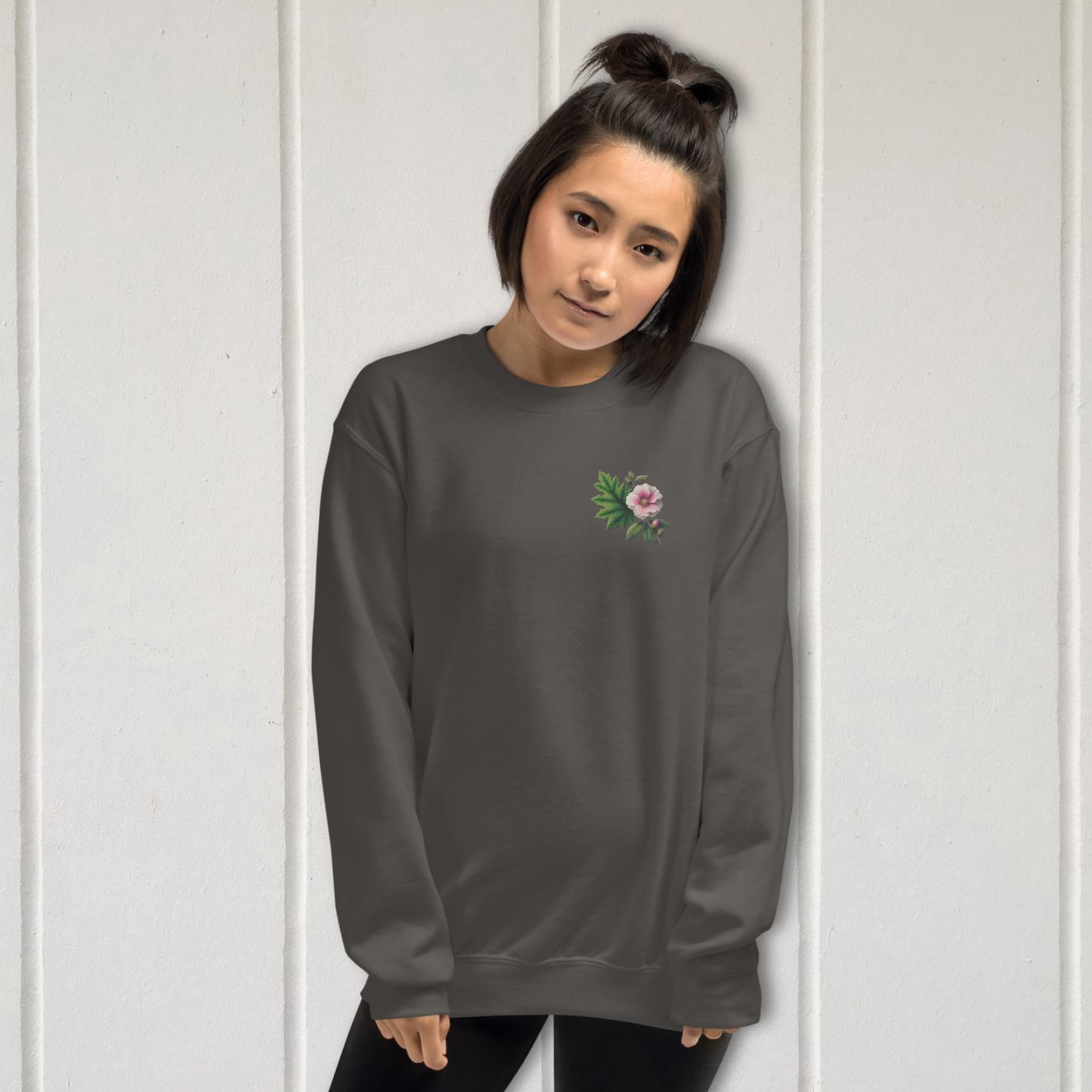 Person wearing a dark gray long-sleeve shirt with a floral design on a white background  - mugunghwa and oak leaf botanical design - medium grey gray sweatshirt - [SAMPLE SALE] Mugunghwa & Oak Leaf Embroidered Sweatshirt (Unisex) | Serendipitous Landing