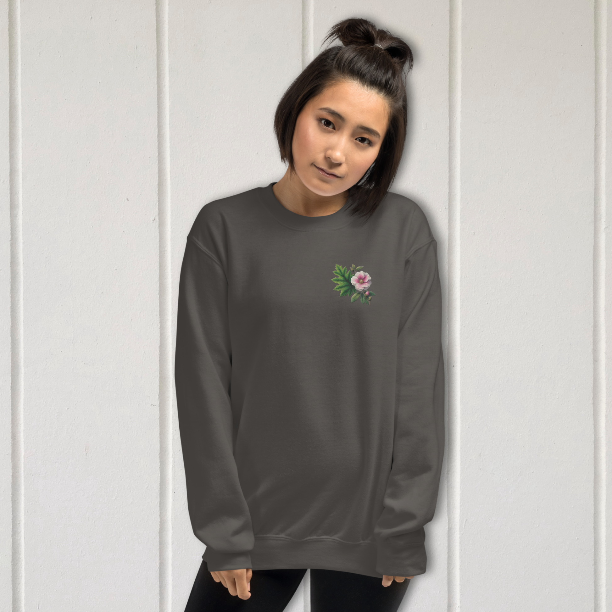 Person wearing a dark gray long-sleeve shirt with a floral design on a white background  - mugunghwa and oak leaf botanical design - medium grey gray sweatshirt - [SAMPLE SALE] Mugunghwa & Oak Leaf Embroidered Sweatshirt (Unisex) | Serendipitous Landing