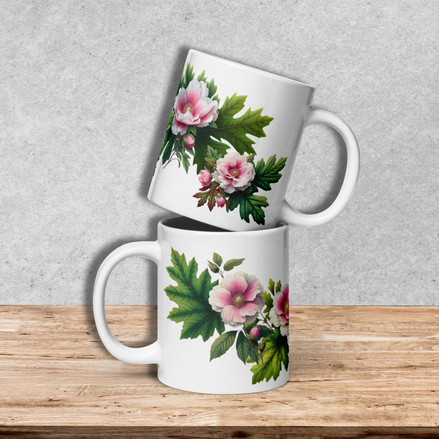 Two white mugs with floral designs stacked on a wooden surface and gray background - mugunghwa and oak leaf botanical design - 20 oz ceramic mug