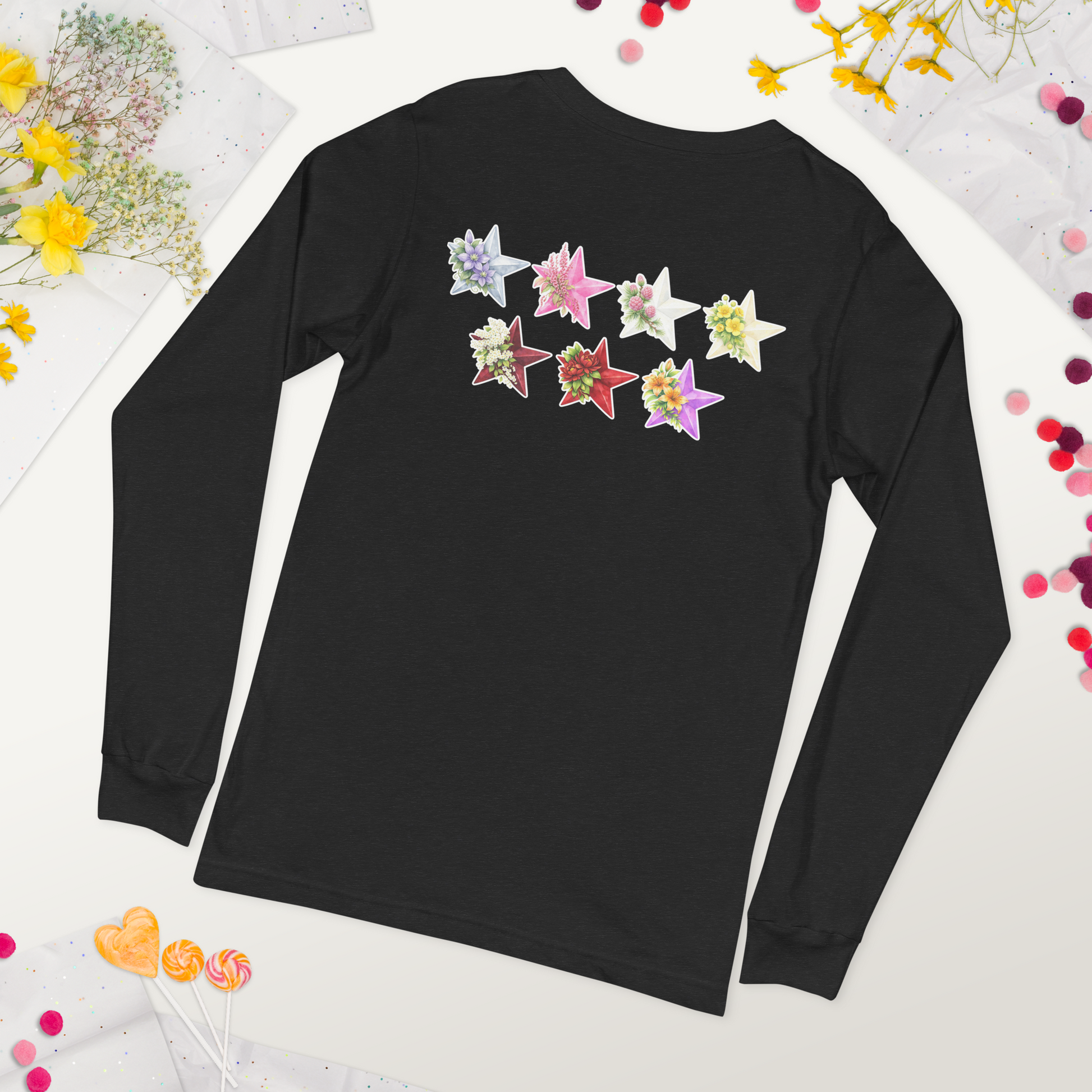 Black long-sleeve shirt with colorful star-shaped designs on a white background with flowers and confetti. - The Insignia Bloom Long Sleeve Shirt (Unisex) - 7 Stars collection design - BTS / Bangtan members birth flowers and Arirang vinyl colors