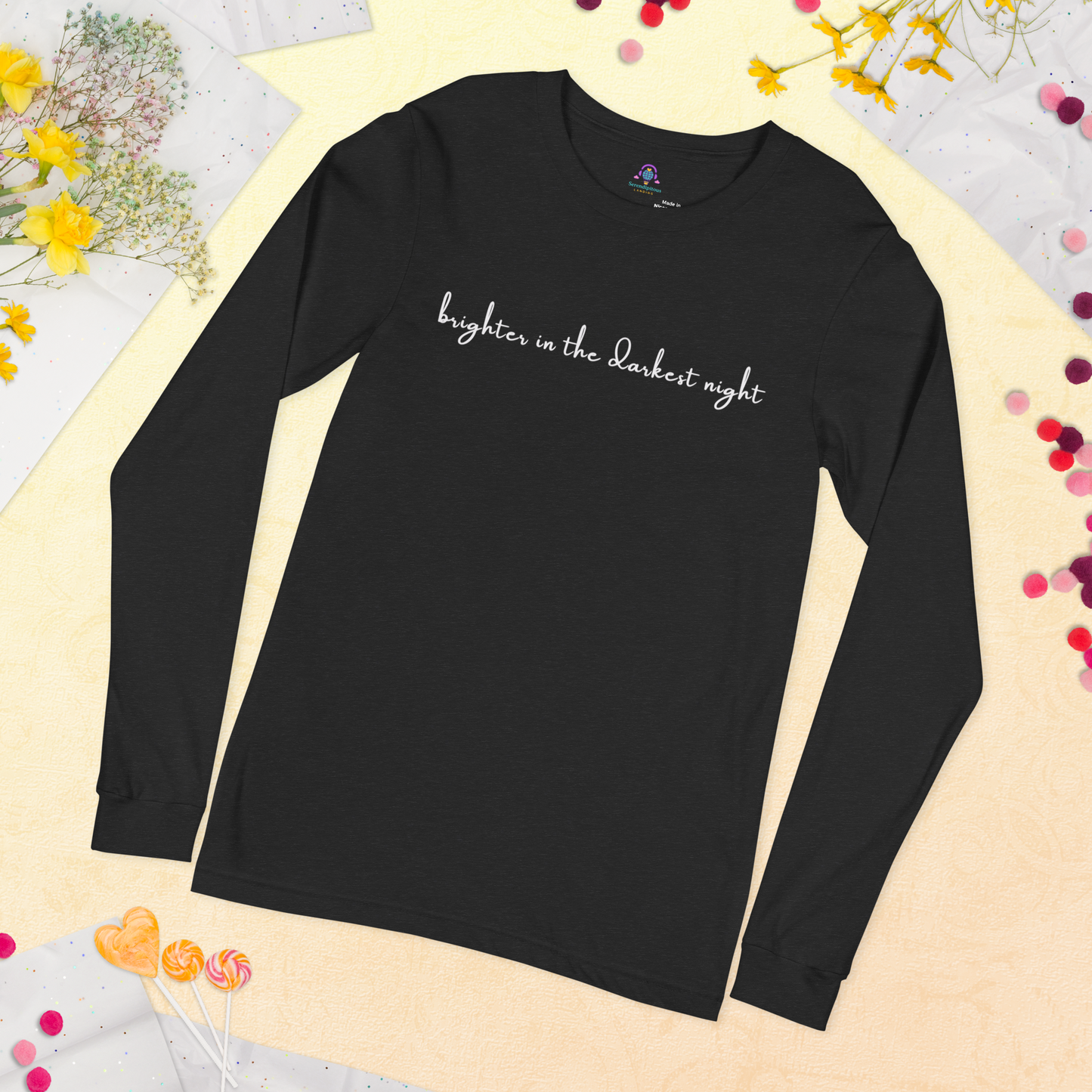 Black long-sleeve shirt with 'brighter in the darkest night' text on a decorative background with flowers and confetti. - The Insignia Bloom Long Sleeve Shirt (Unisex) - 7 Stars collection design - BTS / Bangtan members birth flowers and Arirang vinyl colors