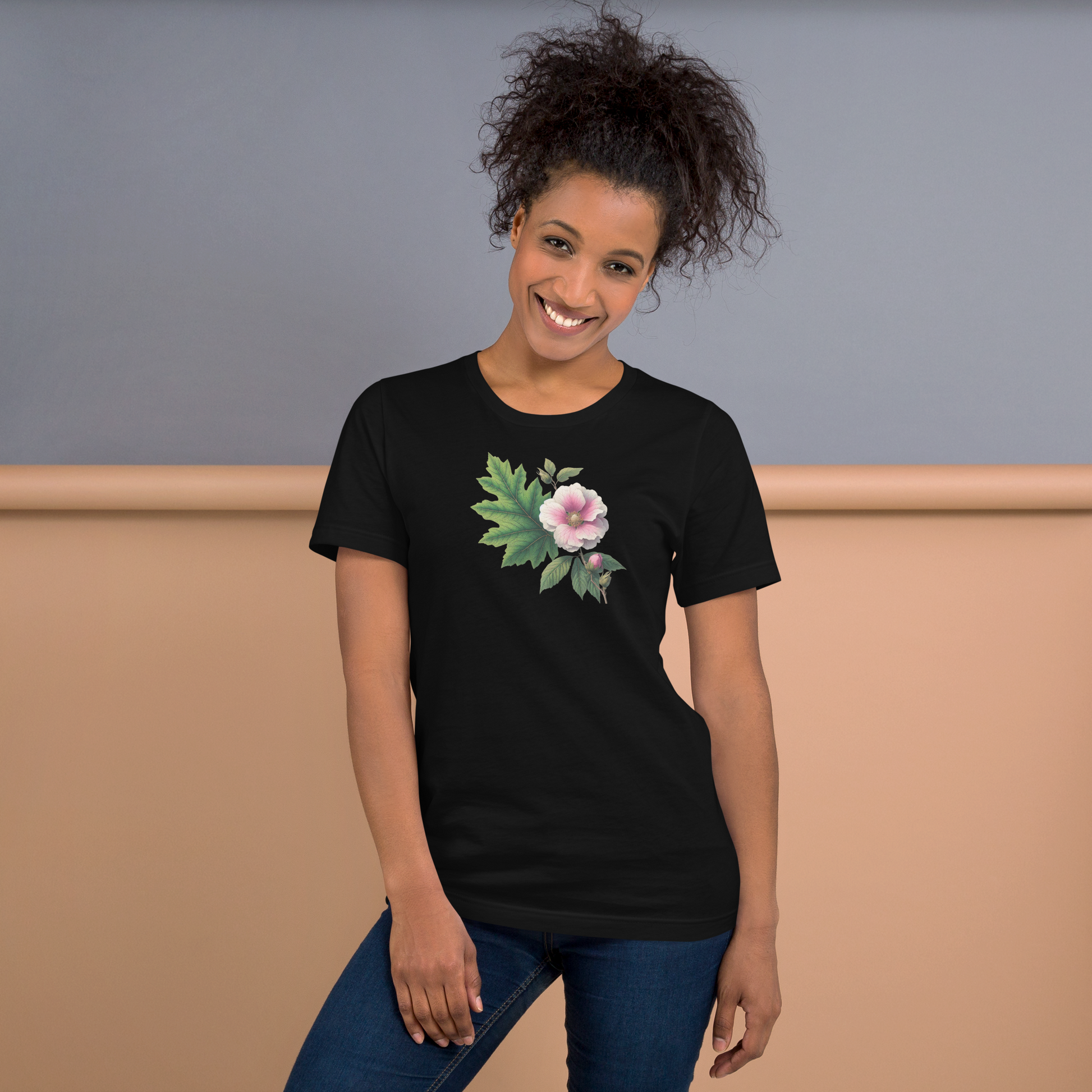 Woman wearing a black t-shirt with a floral design against a neutral background - mugunghwa and oak leaf botanical design - black short sleeve tshirt